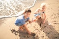 Cute little children gathering sea shells on beach Royalty Free Stock Photo