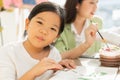 cute little children happy, smile, wear white shirt, look at camera, painting color on paper art in education classroom. asian Royalty Free Stock Photo