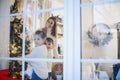 Little children helping parents to decorate Xmas tree, preparing house for Christmas and New Year Royalty Free Stock Photo