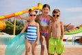 Cute little children with inflatable ring near pool in water park Royalty Free Stock Photo