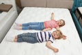 Cute little children lying on new orthopedic mattress
