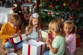 Cute children opening  Christmas gift at home Royalty Free Stock Photo