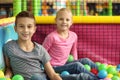 Cute little children playing in ball pit at indoor park Royalty Free Stock Photo