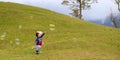 Cute little children playing bubbles on a hill at one of Borneo`s highlands, Ranau, Sabah