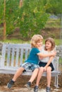 Cute little children playing outdoors. Portrait of two happy young kids at the summer park. Brother hugging her sister. Royalty Free Stock Photo