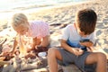 Cute little children playing with sea shells on beach Royalty Free Stock Photo