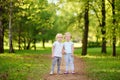 Cute little children playing together and holding hands in sunny summer park Royalty Free Stock Photo