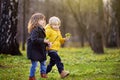 Cute little children playing together in sunny spring park Royalty Free Stock Photo