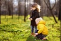 Cute little children playing together in sunny spring park Royalty Free Stock Photo
