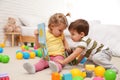 Cute little children playing with toys on floor Royalty Free Stock Photo