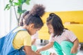 Cute little children playing toys in living room, Diverse children enjoying playing with toys Royalty Free Stock Photo