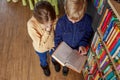 Cute little children reading books in library. Concept of studying, back to school and friends Royalty Free Stock Photo