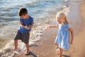 Cute little children with sea shells on beach Royalty Free Stock Photo