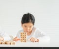 cute little children serious play alphabet block on table. asian children study and learn alphabet, scrabble, crossword in Royalty Free Stock Photo