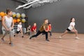 Cute little children and trainer doing physical exercise in school gym. Healthy lifestyle