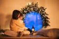 Cute little children waiting for miracle on Christmas Eve, kids looking out window on xmas evening Royalty Free Stock Photo