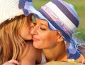 Cute little daughter kissing her mother Royalty Free Stock Photo