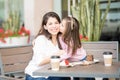 Daughter kissing her mother at cafe Royalty Free Stock Photo