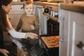 Cute little daughter and mother baking christmas gingerbread cookies in modern scandinavian kitchen. Cute toddler girl and mom Royalty Free Stock Photo