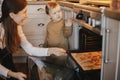 Cute little daughter and mother baking christmas gingerbread cookies in modern scandinavian kitchen. Cute toddler girl and mom Royalty Free Stock Photo