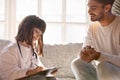 Cute little daughter playing doctor or nurse with happy father