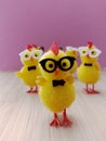 Cute little Easter chicks wearing glasses on a purple and wood background Royalty Free Stock Photo