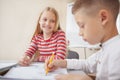 Cute little elementary school students drawing in class together Royalty Free Stock Photo