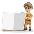 Cute little explorer boy in a safari outfit showing giant book open Royalty Free Stock Photo