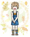 Cute little fair-haired girl standing on background of autumn la