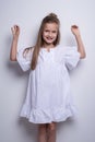 Cute little fashion model on white background. Beautiful girl studio shot. Royalty Free Stock Photo