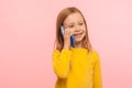 Cute little ginger girl with freckles smiling joyfully while calling parents on cell phone, good cellular, roaming Royalty Free Stock Photo