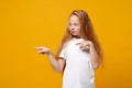 Cute little ginger kid girl 12-13 years old in white t-shirt isolated on yellow wall background children studio portrait Royalty Free Stock Photo