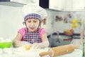 Cute little girl in apron baking cookies at home Royalty Free Stock Photo