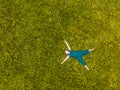 Cute little girl lying on green grass in park Royalty Free Stock Photo