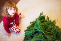 Cute little girl assembling christmas tree.