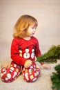 Cute little girl assembling christmas tree.