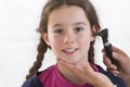 Cute little girl attending a medical check-up Royalty Free Stock Photo