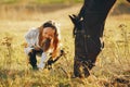 Cute little girl in a autumn field with horse Royalty Free Stock Photo