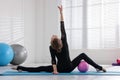 Cute little girl with ball doing gymnastics exercise indoors, back view Royalty Free Stock Photo