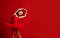 Cute little girl ballerina ballet dancer in beautiful dress is dancing on red Royalty Free Stock Photo