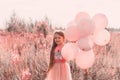 Little girl with balloons trendy coral toned