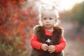 Cute little girl with a basket of red apples in the fall in the park Royalty Free Stock Photo