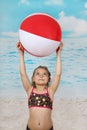 Cute little girl on beach with ball Royalty Free Stock Photo