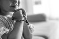 Cute little girl with beads praying indoors, black and white effect Royalty Free Stock Photo