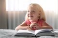 Cute little girl with beads praying over Bible Royalty Free Stock Photo