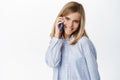 Cute little girl, beautiful blond kid talking on mobile phone, having conversation on smartphone, answer a call Royalty Free Stock Photo