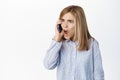 Cute little girl, beautiful blond kid talking on mobile phone, having conversation on smartphone, answer a call Royalty Free Stock Photo