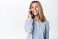 Cute little girl, beautiful blond kid talking on mobile phone, having conversation on smartphone, answer a call Royalty Free Stock Photo