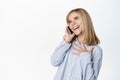 Cute little girl, beautiful blond kid talking on mobile phone, having conversation on smartphone, answer a call Royalty Free Stock Photo
