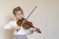 Cute little girl in a beautiful dress playing violin. Joyful and happy emotions. Training. Education. School. Aesthetic Royalty Free Stock Photo